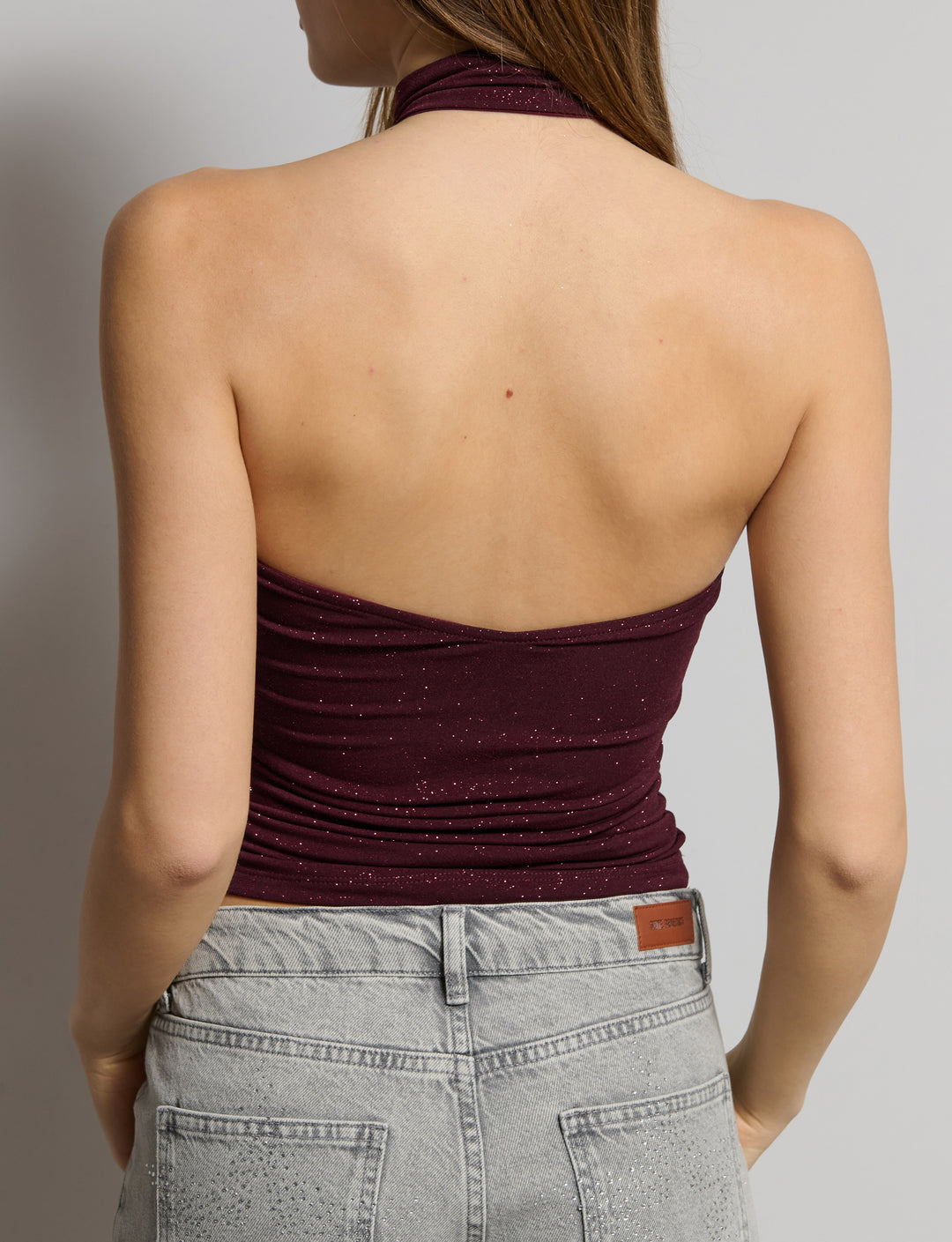 Top a fascia in tessuto glitter con colletto