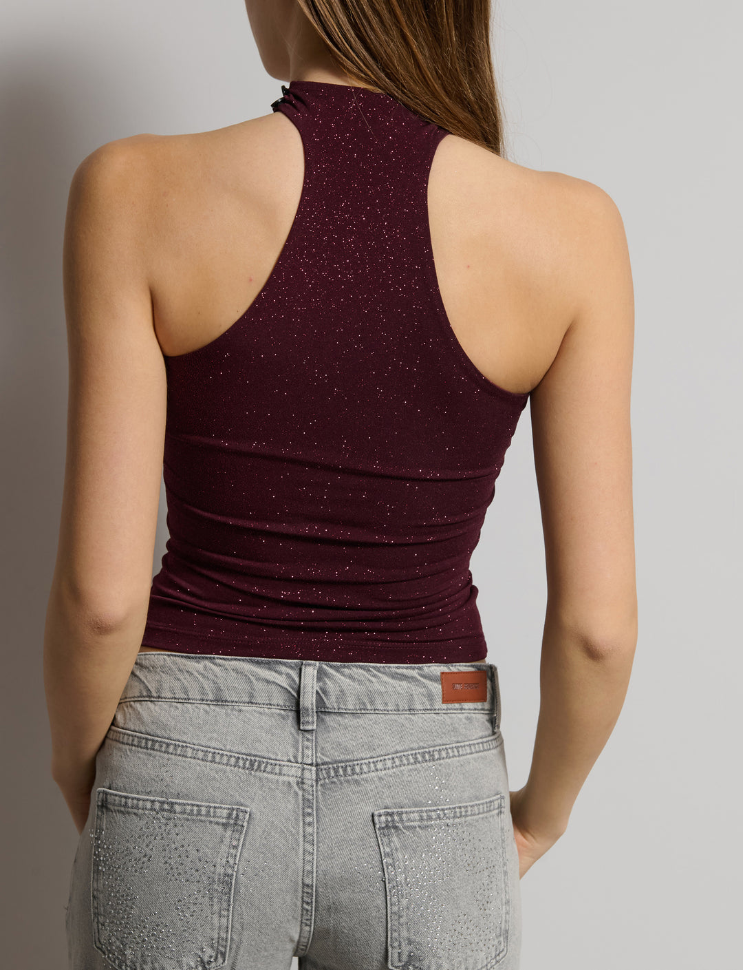 Top a fascia in tessuto glitter con colletto