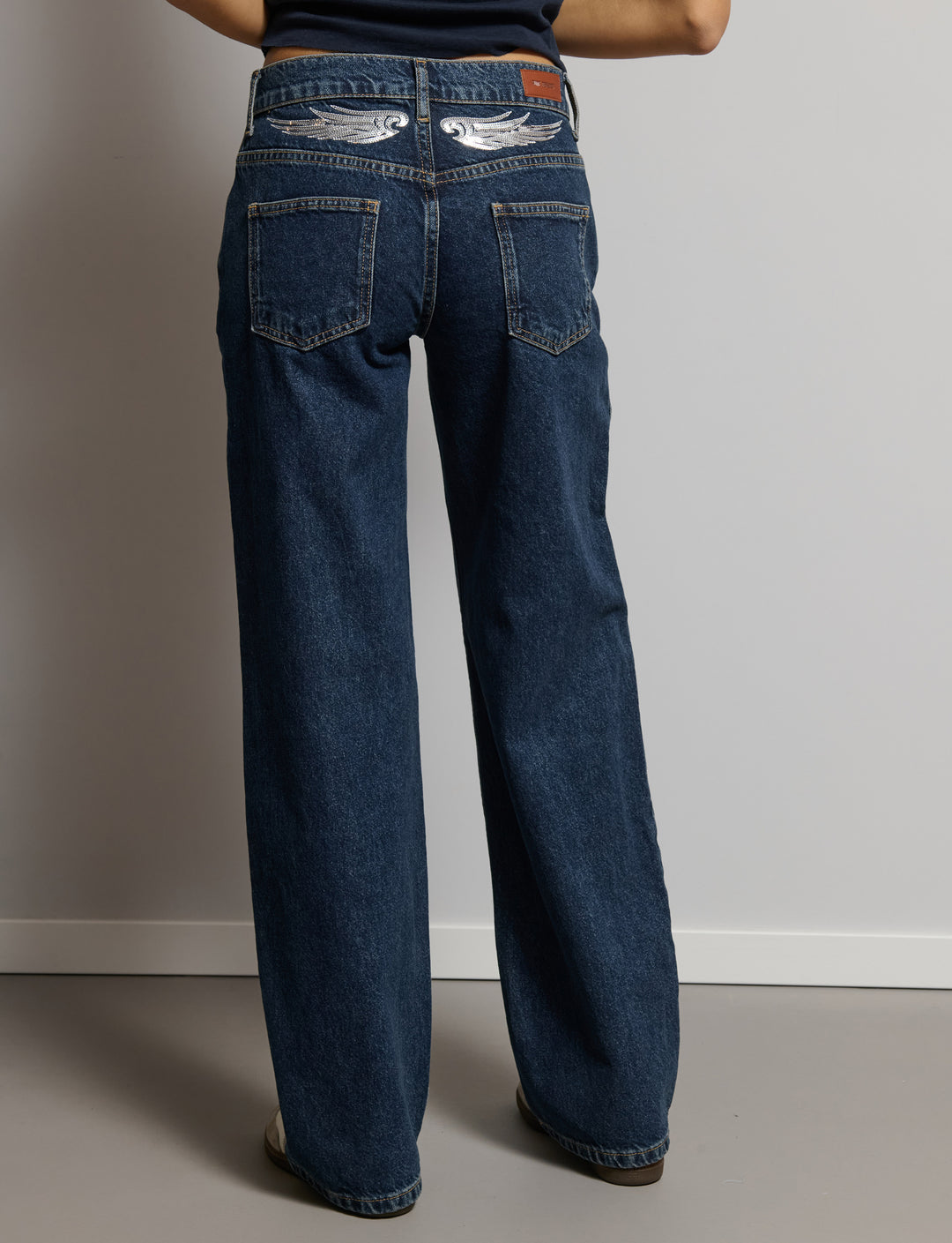 Jeans con ali paillettes