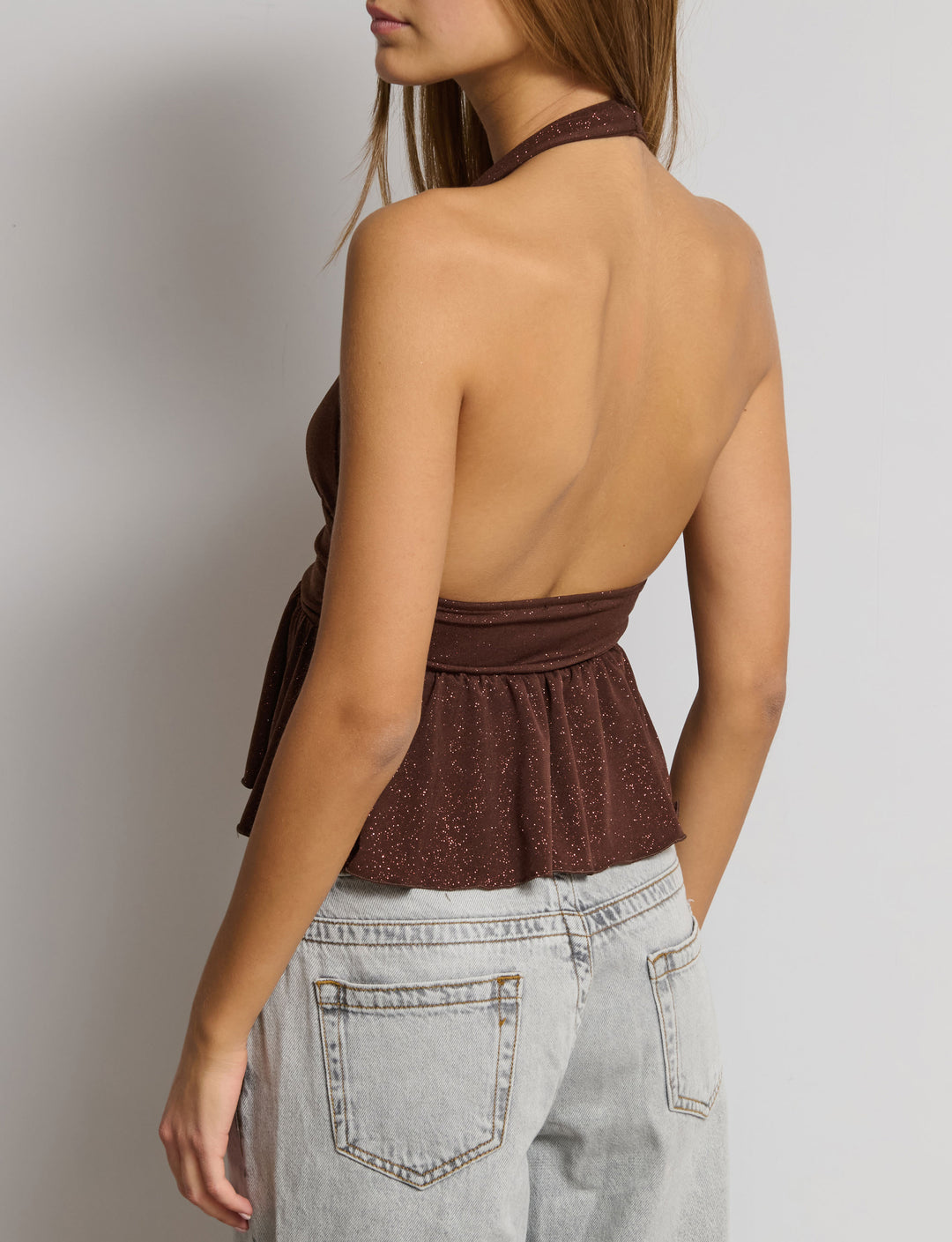 Top glitterato con balza