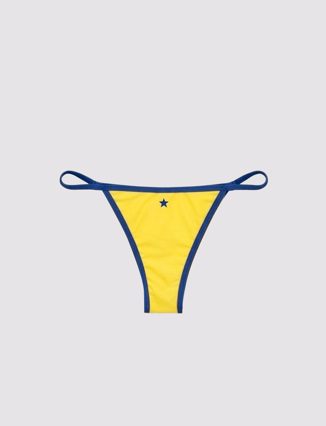 Slip bikini giallo con stella retro still life