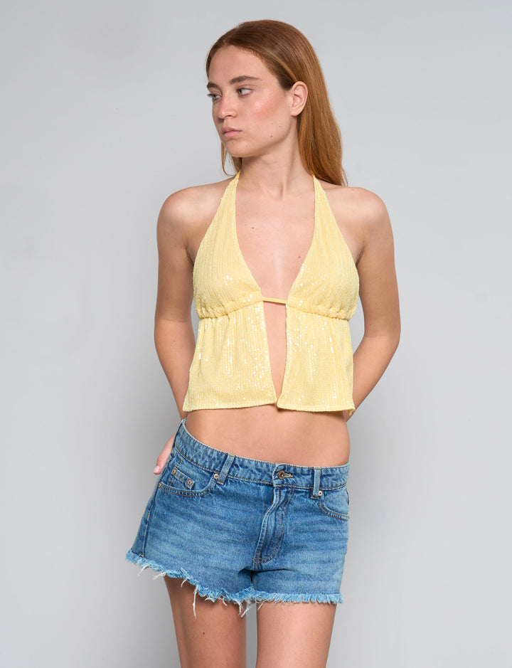 Top giallo in paillettes con schiena scoperta copertina