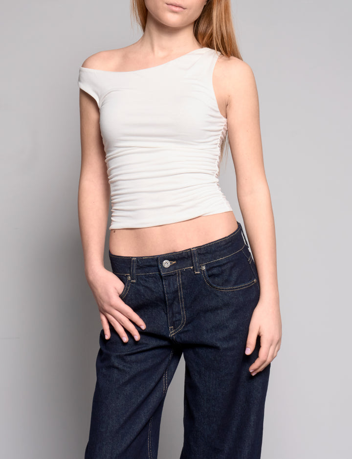 Top panna asimmetrico a manica corta